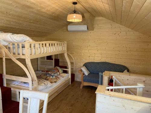 a room with two bunk beds and a chair at Ferienhaus Spielburg in Altötting