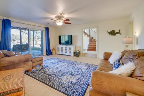 a living room with a couch and a tv at Spacious Vacation Rental Home on Eufaula Lake! in Eufaula