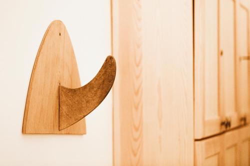 a wooden arrow hanging on a wall next to a door at Imsouane Surf Paradise in Imsouane