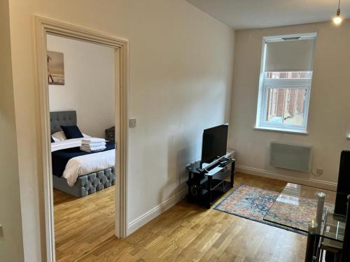 a room with a bedroom with a bed and a mirror at Quiet, Private and Serene in Southend-on-Sea