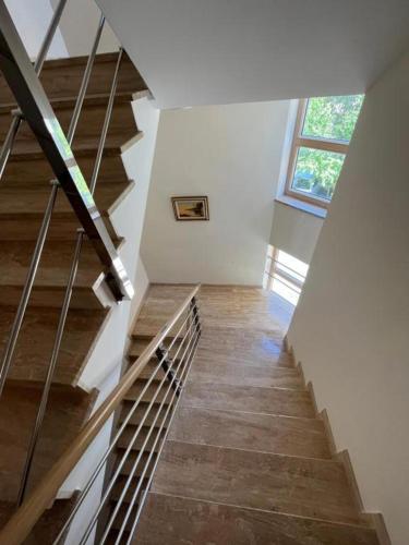 a staircase in a house with a window at Apartman Ambasador in Makarska