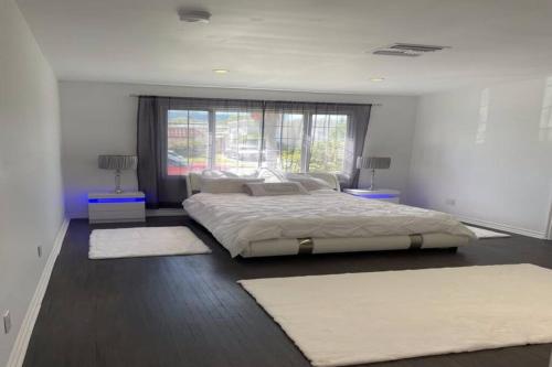a bedroom with a large bed and two rugs at 3 Bd Beverly Hills House in Los Angeles