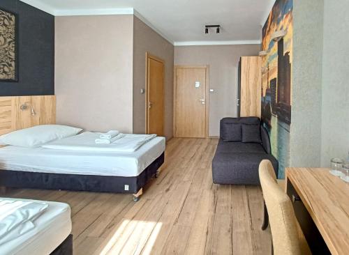 a hotel room with a bed and a chair at Kamienica Morska Gdynia in Gdynia