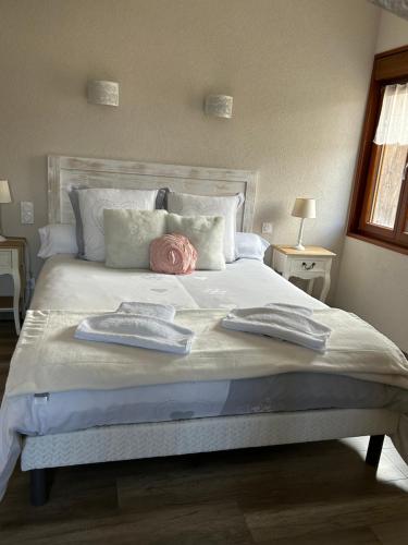 a bedroom with a large bed with two towels on it at L'ECRIN DU LAC chambres d'hôtes in Saint-Point-Lac