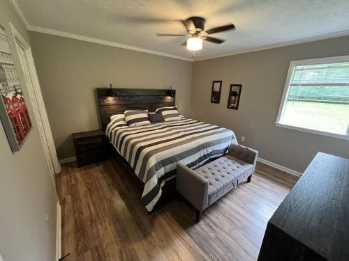 a bedroom with a bed and a ceiling fan at Spacious 3 bedroom home near Amphitheater/Baseball/shopping and much more in Pearl