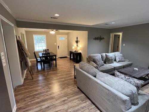 a living room with a couch and a table at Spacious 3 bedroom home near Amphitheater/Baseball/shopping and much more in Pearl