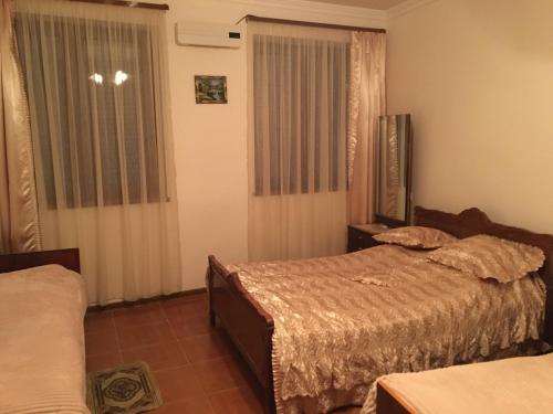 a bedroom with two beds and a window at Syunyats guest house in Halidzor