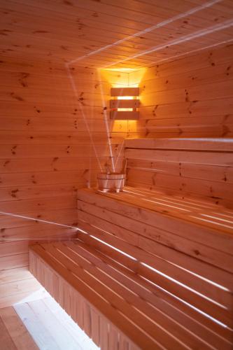 an empty wooden sauna with a light in it at Anielski Zakątek Solina - balia z jacuzzi i sauna w cenie pobytu in Solina