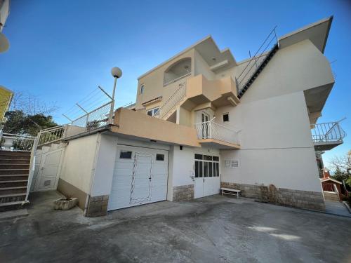 a house with a cube on top of it at Apartments Jurisic in Baška Voda