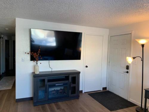 a living room with a flat screen tv on a wall at Newly Remodeled Relaxing Stay near Downtown in Fairbanks