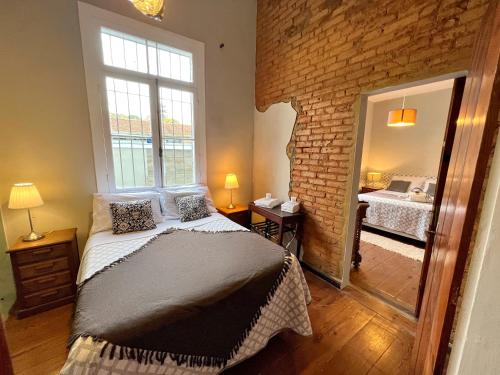 a bedroom with a large bed and a mirror at Casa Verde Petrópolis in Petrópolis