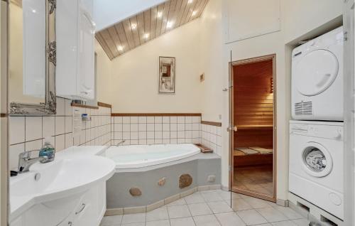 a bathroom with a sink and a washing machine at 3 Bedroom Gorgeous Home In Højslev in Højslev