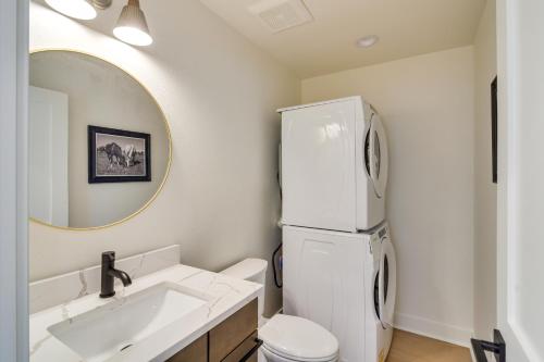 een witte badkamer met een wastafel en een koelkast bij Modern Erie Home - Walk to Downtown! in Erie