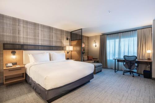 a hotel room with a large bed and a desk at Residence Inn by Marriott San Francisco Airport Millbrae Station in Millbrae