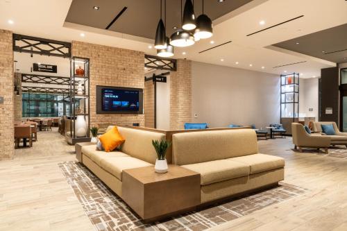 an office lobby with a couch and a tv at Residence Inn by Marriott San Francisco Airport Millbrae Station in Millbrae