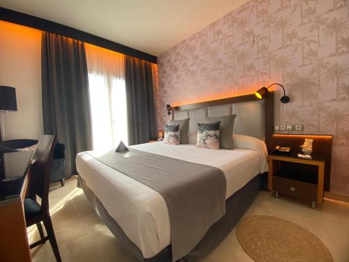a bedroom with a large bed in a hotel room at ON ALETA ROOM designed for adults in Almuñécar