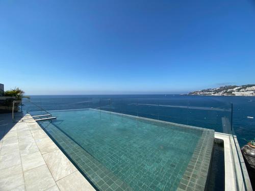 a swimming pool with a view of the ocean at ON ALETA ROOM designed for adults in Almuñécar