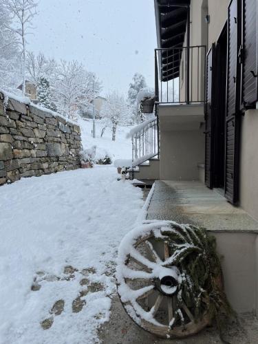 a pile of snow on the ground next to a building at Tenuta Rella in Dronero