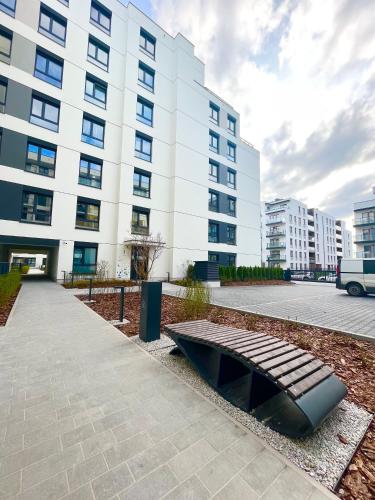 a bench in front of a large building at Warsaw Inside Airport & Business Premium in Warsaw