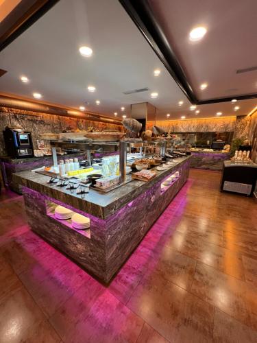 a buffet line in a restaurant with purple lighting at ON ALETA ROOM designed for adults in Almuñécar