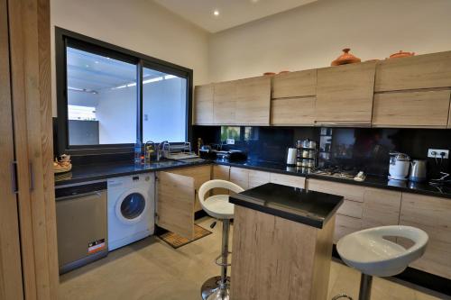 a kitchen with a washing machine and a sink at Moon house in Ville Nouvelle
