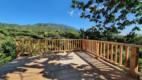 a wooden bridge with a view of the mountains at Casa Katok in Sonsonate