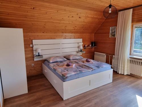 a bedroom with a large bed in a wooden room at Room Sodja in Bohinj