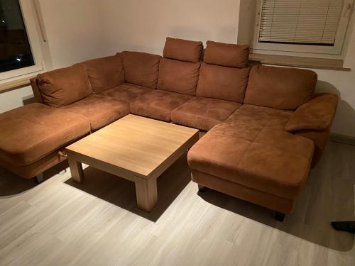 a brown couch and a coffee table in a living room at 3 Zimmer Apartment in Bayreuth