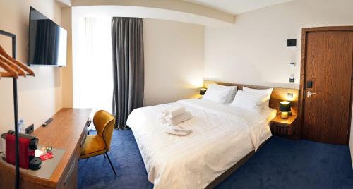 Ένα ή περισσότερα κρεβάτια σε δωμάτιο στο Hotel Tiflisi Inn