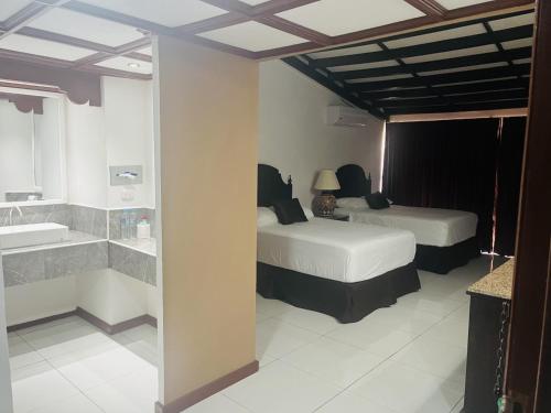 Łóżko lub łóżka w pokoju w obiekcie HOTEL TESORO BEACH