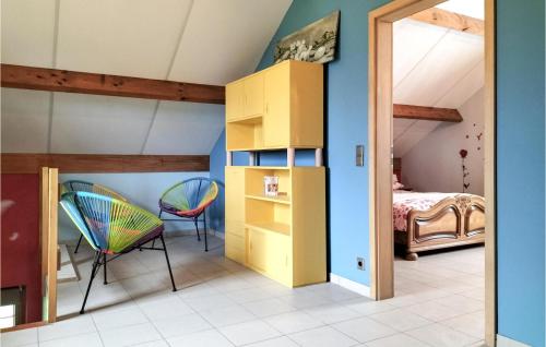 Habitación con armario amarillo y 2 sillas en Nice Home In Somme-leuze With Wifi, en Somme-Leuze