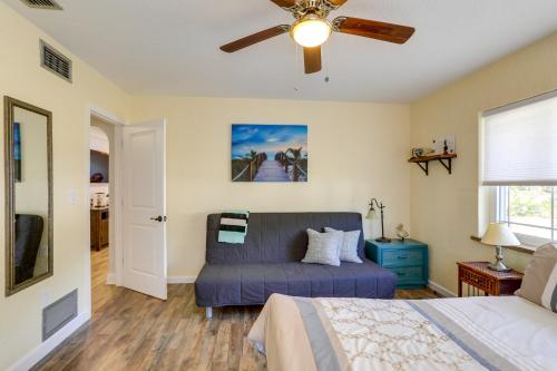 a bedroom with a blue bed and a ceiling fan at Charming Home with Yard about 5 Mi to Clearwater Beach! in Clearwater