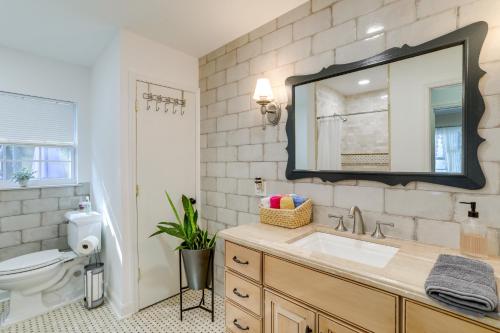 a bathroom with a sink and a toilet and a mirror at Charming Home with Yard about 5 Mi to Clearwater Beach! in Clearwater