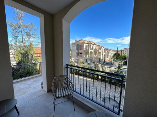 a balcony with a chair and a view of a street at LUSTICA BAY GARDEN STUDIO, Centrale in Tivat