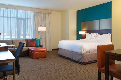 a hotel room with a bed and a couch at Residence Inn by Marriott Nashville Vanderbilt/West End in Nashville