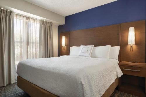 a bedroom with a large bed and a large window at Residence Inn El Paso in El Paso
