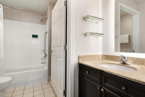 a bathroom with a sink and a tub and a toilet at Residence Inn El Paso in El Paso