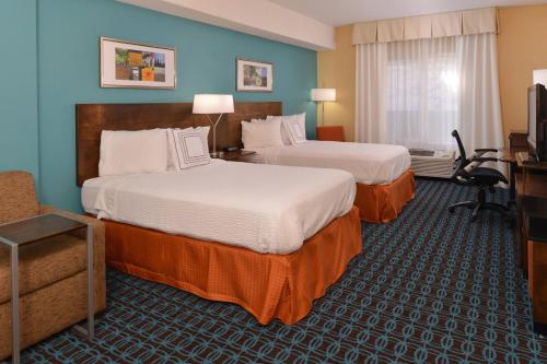 a hotel room with two beds and a television at Fairfield Inn and Suites by Marriott Dayton Troy in Troy