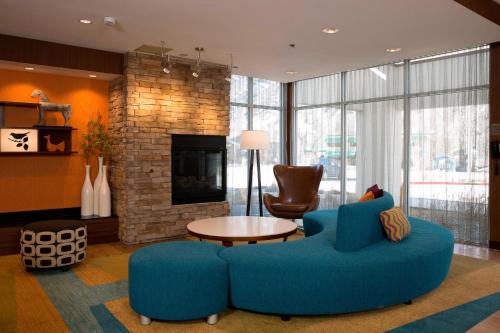 a living room with a blue couch and a fireplace at Fairfield Inn & Suites by Marriott Durango in Durango