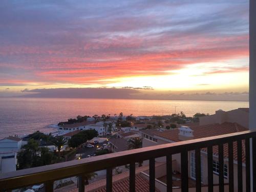 a view of the ocean from a balcony at sunset at Sunset Seaview La Arena in Puerto de Santiago