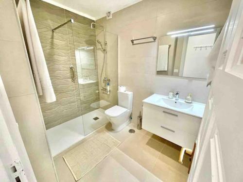 een badkamer met een toilet, een douche en een wastafel bij Sunset Seaview La Arena in Puerto de Santiago