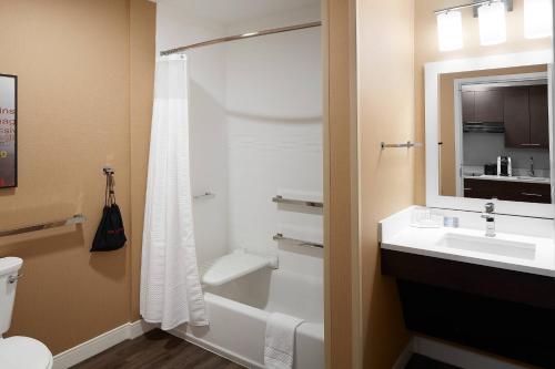 a bathroom with a shower and a sink and a toilet at TownePlace Suites by Marriott Danville in Danville