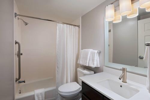 a bathroom with a sink and a toilet and a shower at TownePlace Suites by Marriott Baton Rouge South in Baton Rouge