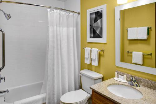 a bathroom with a toilet and a sink and a shower at TownePlace Suites Fresno in Fresno