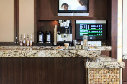 a bar in a hotel with a tv above it at Charleston Marriott Town Center in Charleston