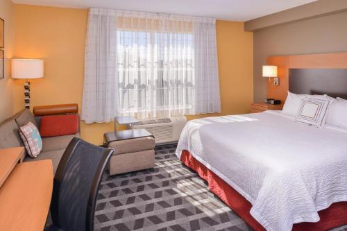 a hotel room with a large bed and a window at TownePlace Suites Arundel Mills BWI Airport in Hanover