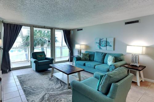 a living room with a couch and chairs and a table at Sabine Yacht & Racquet #1B in Pensacola Beach