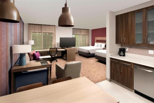 a living room with a kitchen and a hotel suite at Residence Inn by Marriott Baltimore Owings Mills in Owings Mills