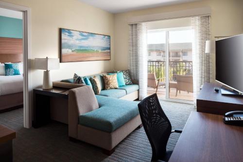 a hotel room with a couch and a bed and a desk at Residence Inn by Marriott Maui Wailea in Wailea