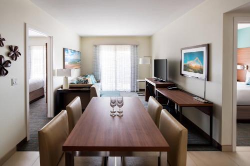 a hotel room with a dining table and a bedroom at Residence Inn by Marriott Maui Wailea in Wailea